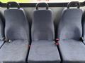 Three blue fabric seats with seatbelts in a row from a 2018 Chevrolet Express van