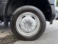 A close-up view of a silver wheel and tire from a 2017 Ford F-550 with a Continental tire tread and visible lug nuts