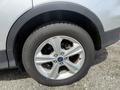 Close-up of a silver 2015 Ford Escape wheel featuring a five-spoke alloy design and a black tire with a tread pattern