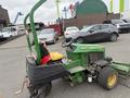 A 2009 John Deere 2653B Precision mower with a green body yellow seat and attached cutting deck parked in a lot