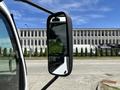 Side mirror of a 2018 Hino 195 truck angled outward showing reflective surface and black casing