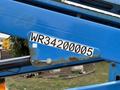 A blue Genie TZ-34/20 aerial lift with a visible identification number WR342000005 on the side