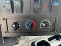 Control panel of a 2020 Freightliner MT45 featuring switches for cab lights heated mirrors and knobs for temperature and airflow adjustment