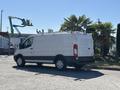 A 2016 Ford Transit van parked with a white exterior and a low roof design
