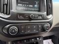The center console of a 2017 Chevrolet Colorado featuring climate control buttons radio interface and knobs for temperature and air conditioning settings