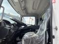 Interior view of a 2018 Hino 338 truck showing the driver's seat wrapped in plastic and the steering wheel with various controls visible