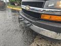 A 2018 Chevrolet Express van with a chrome front grille and bumper featuring two mounting points for towing or accessories