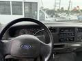 The interior view of a 2004 Ford F-350 SD showing the steering wheel dashboard and audio controls
