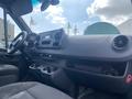 Interior view of a 2024 Mercedes-Benz Sprinter showcasing the dashboard with controls air vents and seating area