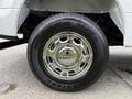 A close-up of a chrome wheel on a 2018 Ford F-150 with a black tire featuring the text DUELER H/T and a visible tread pattern