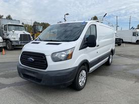 White 2017 Ford Transit van with a black grille and chrome accents parked with its driver side facing forward