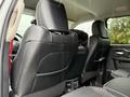 The interior of a 2024 RAM 5500 showing leather upholstery on the rear seats with visible stitching and a view of the front interior dashboard