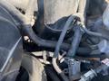 2011 Chevrolet Express engine components showing a network of wires and hoses in the foreground