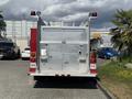 A 1994 Volvo FE 42 fire truck with a metal body featuring red lights at the top and various compartments on the rear for equipment storage