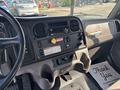 Interior dashboard of a 2019 Freightliner M2 106 featuring various gauges buttons and controls with a floor mat that says Thank You It's Been Pleasure Serving You