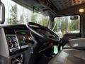 Interior of a 2018 Kenworth T800 featuring a detailed dashboard with gauges and controls a steering wheel and leather seats