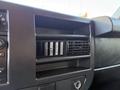 Dashboard interior of a 2015 GMC Savana featuring an air vent and control panel with buttons and dials