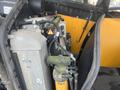 Close-up of the engine compartment of a 2013 JCB 510-56 Loadall showing various components including filters pipes and a hydraulic reservoir