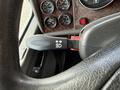 Close-up of a 2008 Kenworth T370 steering wheel with a lever for turning signals displayed on the left side