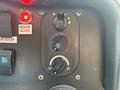 Control panel of a 2018 Ford Econoline featuring knobs for temperature and airflow settings along with buttons for door and mirror adjustments
