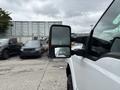 A white 2013 Ford F-250 SD truck with a side mirror facing outward