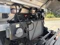 A close-up view of the engine compartment of a 2011 Workhorse W62 displaying the radiator and various engine components with hoses and fluid reservoirs