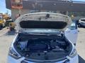 A 2018 Hyundai Santa Fe with its hood open revealing the engine and various components inside the engine bay