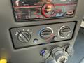 Control panel of a 2022 Lion Lion6 featuring temperature dials and a media system with buttons and a display