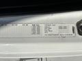 Label on a 2006 Freightliner M2 106 door frame detailing specifications such as axle weight ratings and vehicle identification information