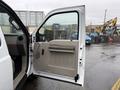A 2008 Ford F-250 SD with an open front door showing the interior door panel and handle