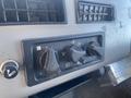 Control panel of a 1997 Freightliner FL70 featuring knobs for temperature and airflow adjustment