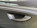 A close-up of the interior door handle of a 2022 Mercedes-Benz Sprinter showing the design and controls for locking and unlocking the door