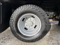 A close-up of a chrome wheel with a rugged tire mounted on a 2015 Ford F-350