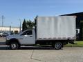 A 2016 RAM 5500 truck with a white box cargo bed and dual rear wheels parked on a lot
