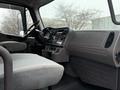 Interior view of a 2019 Freightliner M2 showing the driver's seat dashboard and control panel