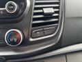 The dashboard of a 2020 Ford Transit 250 featuring air conditioning controls a tune knob and a button labeled off