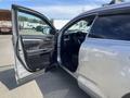 A 2018 Toyota Highlander with the driver's side door open showcasing the interior features and seating arrangement