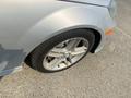 A silver 2013 Mercedes-Benz C-Class with a close-up view of its tire and alloy wheel