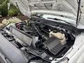 A 2013 Ford F-250 SD with its hood raised displaying the engine compartment featuring various components and systems