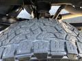 Close-up view of a 2018 RAM 3500 tire showing deep tread patterns with rugged texture and dirt accumulation