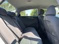 The interior of a 2015 Hyundai Sonata with a focus on the rear seating area featuring gray fabric seats and seatbelts