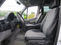 Interior view of a 2009 Dodge Sprinter Van featuring two front seats with fabric upholstery and a dashboard with controls