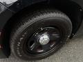 Close-up of the wheel and tire of a 2017 Dodge Charger showing a black rim with a silver center cap and a treaded Firehawk tire