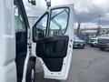 2023 RAM Promaster 3500 with the driver's door open showcasing the interior door handle and panel design
