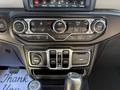 The image shows the interior dashboard controls of a 2021 Jeep Gladiator featuring various dials buttons and a central display screen