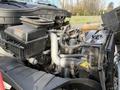 The image shows the engine compartment of a 2013 International Durastar 4300 with various components like air filters hoses and pipes visible