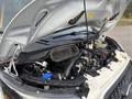 A 2021 Ford Transit-350 with its hood lifted revealing the engine compartment and various components including hoses and fluid reservoirs