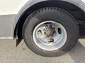 Close-up of the wheel of a 2018 Chevrolet Express featuring a silver rim with blue and gold accents and a black tire