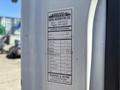 A service record label attached to a 2011 International 4300 showing details of maintenance performed including mileage and tasks like oil change and fluid checks