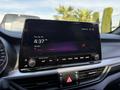 Dashboard display of a 2024 Kia Forte5 showing time and radio station information